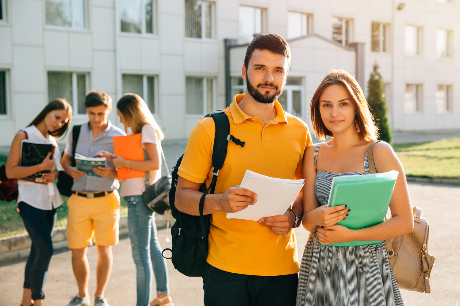 two-happy-students-with-backpacks-books-their-hands-smiling-camera